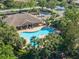 Aerial view of community pool and clubhouse featuring mature landscaping at 7403 Hamilton Rd, Bradenton, FL 34209