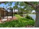 Backyard view of lanai, beautiful landscaping, and serene lake at 7403 Hamilton Rd, Bradenton, FL 34209