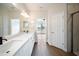 Bathroom with double sink vanity, stone countertops, and a view of the lake at 7403 Hamilton Rd, Bradenton, FL 34209
