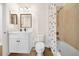 Well-lit bathroom featuring a vanity and a shower/tub combination with stylish shower curtain at 7403 Hamilton Rd, Bradenton, FL 34209