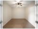 A cozy bedroom with neutral carpet and a ceiling fan at 7403 Hamilton Rd, Bradenton, FL 34209