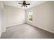 Neutral bedroom with light colored carpet, a ceiling fan, and a bright window at 7403 Hamilton Rd, Bradenton, FL 34209