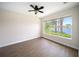 Bedroom with tile flooring and a large window overlooking a serene lake at 7403 Hamilton Rd, Bradenton, FL 34209