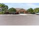 Exterior of the community clubhouse with ample parking and attractive landscaping at 7403 Hamilton Rd, Bradenton, FL 34209