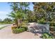 Paver entrance featuring beautiful landscaping, including palm trees, shrubs, and flowers at 7403 Hamilton Rd, Bradenton, FL 34209