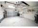 Spacious two car garage featuring painted floor, shelving, and garage door opener at 7403 Hamilton Rd, Bradenton, FL 34209