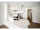 Bright kitchen features white cabinets, stainless steel appliances, and a breakfast bar with wood floors at 7403 Hamilton Rd, Bradenton, FL 34209