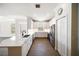 Modern kitchen features white cabinets, stainless steel appliances, and a breakfast bar with wood floors at 7403 Hamilton Rd, Bradenton, FL 34209