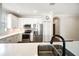 Modern kitchen features white cabinets, stainless steel appliances, and a stylish sink with stone countertops at 7403 Hamilton Rd, Bradenton, FL 34209