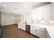 Modern kitchen featuring white cabinets, stainless steel appliances, and stone countertops in an open layout at 7403 Hamilton Rd, Bradenton, FL 34209
