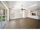Spacious living room features wood floors, a modern ceiling fan, and sliding doors at 7403 Hamilton Rd, Bradenton, FL 34209