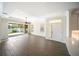 Bright living room offers wood floors, a modern ceiling fan, a large window, and a white front door at 7403 Hamilton Rd, Bradenton, FL 34209