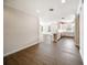 Open-concept interior featuring wood floors and seamless transition to the modern kitchen and bright windows at 7403 Hamilton Rd, Bradenton, FL 34209