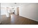 Open-concept interior features wood floors and seamless transition to the modern kitchen with stainless appliances at 7403 Hamilton Rd, Bradenton, FL 34209