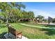 A walking path with benches goes through a grassy area of the community, adjacent to the playground at 7403 Hamilton Rd, Bradenton, FL 34209
