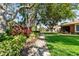 A manicured pathway with lush landscaping and shade trees leads through the residential community at 7403 Hamilton Rd, Bradenton, FL 34209