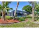 Lush backyard showcasing a screened pool enclosure, landscaping, and a well-maintained lawn at 7442 N Leewynn Dr, Sarasota, FL 34240