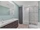 Bright bathroom featuring a double sink vanity, modern fixtures, and a shower with a tub at 7442 N Leewynn Dr, Sarasota, FL 34240