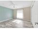 Light-filled bedroom with wood-look flooring, ceiling fan, and a large window at 7442 N Leewynn Dr, Sarasota, FL 34240