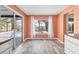 Dining area with bright wall color, wood-look floors and direct access to the screened-in pool area at 7442 N Leewynn Dr, Sarasota, FL 34240