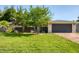 Charming home showcasing a well-manicured lawn and a gray two-car garage at 7442 N Leewynn Dr, Sarasota, FL 34240