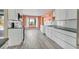 Beautiful kitchen with white cabinets, stainless steel appliances, and wood-look flooring at 7442 N Leewynn Dr, Sarasota, FL 34240