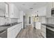 Bright kitchen features gray countertops, stainless steel appliances, and sleek white cabinetry at 7442 N Leewynn Dr, Sarasota, FL 34240