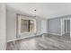 Open-concept living room featuring bright natural light and gray wood-look flooring at 7442 N Leewynn Dr, Sarasota, FL 34240