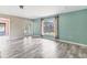Open-concept living room with French doors leading to the pool and green accent wall at 7442 N Leewynn Dr, Sarasota, FL 34240