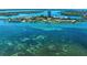 Stunning aerial view of waterfront condos surrounded by crystal-clear turquoise waters at 767 John Ringling Blvd # 25, Sarasota, FL 34236