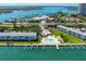 Beautiful aerial view of waterfront condos with boat docks, a pool, and access to Sarasota Bay at 767 John Ringling Blvd # 25, Sarasota, FL 34236