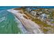 Beautiful aerial view of the beach with turquoise water, modern condos, and pristine sandy beach at 767 John Ringling Blvd # 25, Sarasota, FL 34236