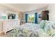 Nicely decorated bedroom with queen bed, side table and dresser at 767 John Ringling Blvd # 25, Sarasota, FL 34236