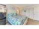 Comfortable bedroom featuring a white bed frame, tropical bedding, and ample closet space at 767 John Ringling Blvd # 25, Sarasota, FL 34236