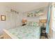 Bedroom featuring tropical bedding, a full closet, and stylish decor at 767 John Ringling Blvd # 25, Sarasota, FL 34236