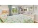 Bright bedroom featuring tropical bedding, a mirror, and stylish decor at 767 John Ringling Blvd # 25, Sarasota, FL 34236