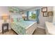 Comfortable bedroom with tropical bedding, a large window, and elegant decor at 767 John Ringling Blvd # 25, Sarasota, FL 34236