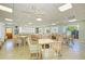 A large community room features ample seating, card tables, and bright windows that offer expansive views at 767 John Ringling Blvd # 25, Sarasota, FL 34236