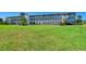 Exterior shot of the apartment complex with a huge grass lawn at 767 John Ringling Blvd # 25, Sarasota, FL 34236