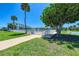 Well-maintained complex featuring lush green lawns, mature trees, and community pool at 767 John Ringling Blvd # 25, Sarasota, FL 34236