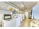 On-site laundry room equipped with multiple washing machines and dryers for resident use at 767 John Ringling Blvd # 25, Sarasota, FL 34236