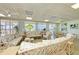 Bright living room featuring plush, floral furniture and expansive windows with scenic water views at 767 John Ringling Blvd # 25, Sarasota, FL 34236