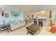 Cozy living room with beach-themed decor and an open layout, flowing into the dining area and kitchen at 767 John Ringling Blvd # 25, Sarasota, FL 34236
