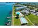 Aerial view showcasing a community pool, shuffleboard, boat docks and well maintained landscaping at 767 John Ringling Blvd # 25, Sarasota, FL 34236