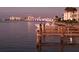 Scenic waterfront view showcasing boat dock with boat, bridge and city lights at dusk at 767 John Ringling Blvd # 25, Sarasota, FL 34236