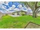 Spacious backyard featuring a well-maintained lawn, patio area, and partial privacy fence, great for outdoor entertaining at 7727 9Th Avenue Nw Dr, Bradenton, FL 34209