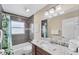 Charming bathroom featuring modern tiling, a white sink, and vanity with marble counters at 7727 9Th Avenue Nw Dr, Bradenton, FL 34209
