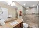 Modern bathroom featuring granite counters, vessel sink, and seamless glass shower with tile surround at 7727 9Th Avenue Nw Dr, Bradenton, FL 34209