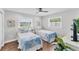 Bedroom featuring two twin beds, wood floors, and natural light at 7727 9Th Avenue Nw Dr, Bradenton, FL 34209