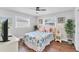 Bright bedroom with a ceiling fan, wood floors, and windows providing natural light at 7727 9Th Avenue Nw Dr, Bradenton, FL 34209